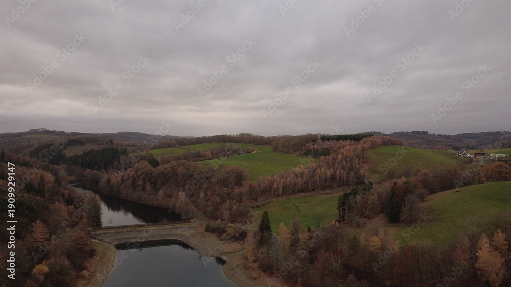 Obraz premium Autumn Lake Aerial View with Soft Light and Rolling Landscape