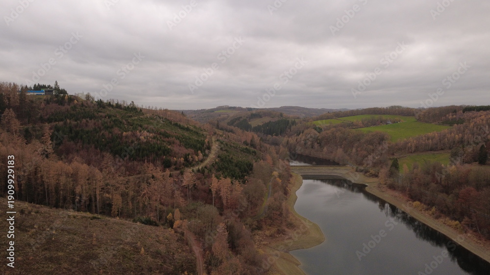 Obraz premium Autumn Lake Aerial View with Soft Light and Rolling Landscape