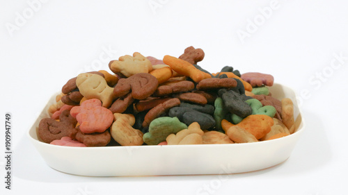 Salty biscuits in the shape of cute animals, ducks, butterflies, elephants, turtles and colorful fish, isolated on a white background. Delicious and sweet biscuit concept.