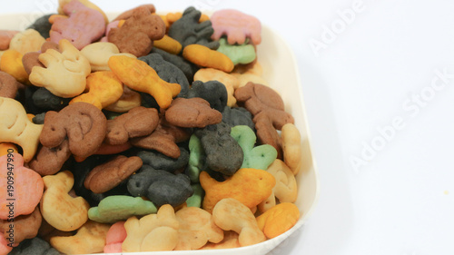 Salty biscuits in the shape of cute animals, ducks, butterflies, elephants, turtles and colorful fish, isolated on a white background. Delicious and sweet biscuit concept.