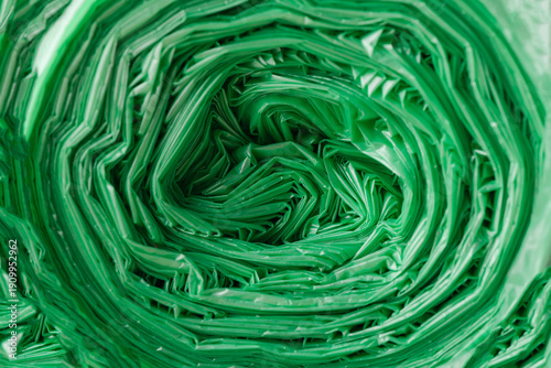 Photos Green plastic trash bags roll creating texture background