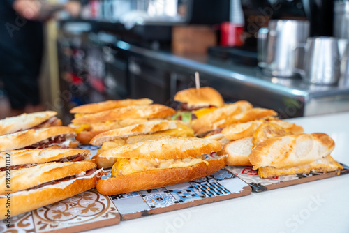 Fotografie Spanish sandwiches bocadillos displayed on a tapas bar counter