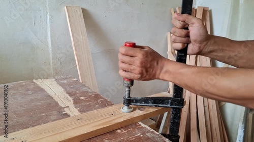 Wallpaper Mural A carpenter is installing clamp to the wooden board. Torontodigital.ca