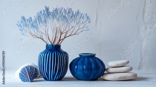 Elegant Arrangement of Blue Vases with Delicate Dried Flowers and Smooth Stones on Minimalist Background for Modern Home Decor Inspiration