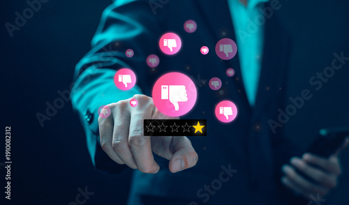 Obraz na płótnie Businessman pointing at one star rating with multiple thumbs down icons, representing negative customer review, low satisfaction score, poor service feedback, online reputation crisis and brand trust