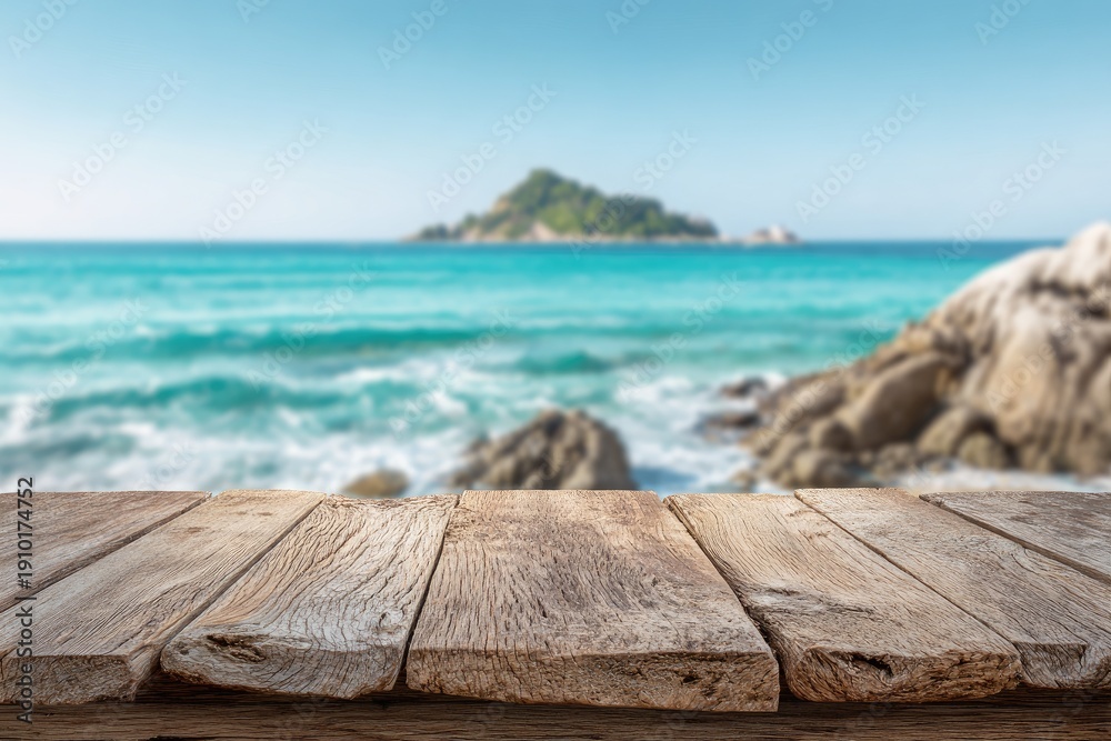 Fototapeta premium Weathered wooden planks foreground serene ocean, distant island, rocky shore
