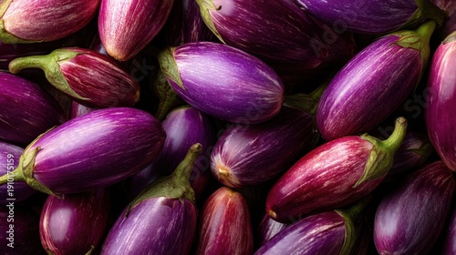 Wallpaper Mural Bunch of purple eggplants are piled on top of each other. The eggplants are purple and green, and they are arranged in a way that makes them look like they are piled on top of each other Torontodigital.ca