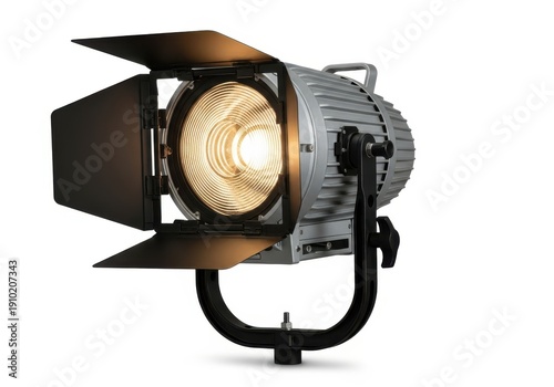 Professional fresnel spotlight illumination device mounted on a yoke stand against a white background