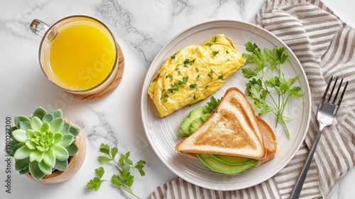 Gourmet Breakfast: A top-down shot of a delectable breakfast spread, featuring a fluffy omelet, avocado toast, and a refreshing glass of orange juice. 