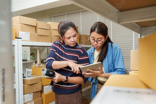 Fotografija Asian adult women small business owners standing near returned parcel boxes whil