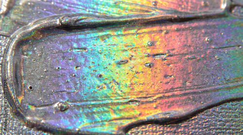 A smear of silver paint on a silver background, an iridescent gradient