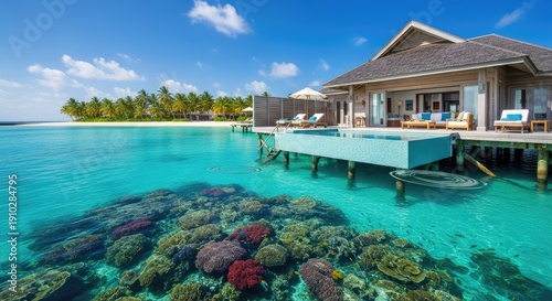 Picturesque overwater bungalow with coral reef and turquoise ocean