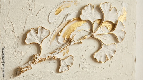 Elegant textured wall art featuring white and gold fan-shaped leaves on a light plaster background in a minimalist interior setting