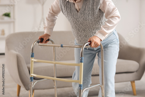 Mature woman using walker a...