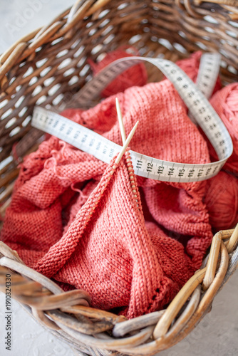 Knitting project with yarn needles and measuring tape