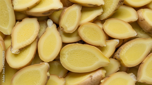 A close-up view of sliced ginger root on a clean surface