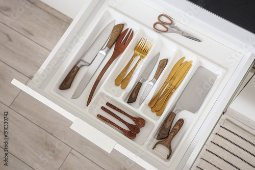 Open drawer with cutlery in...