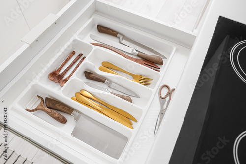 Open drawer with cutlery in...