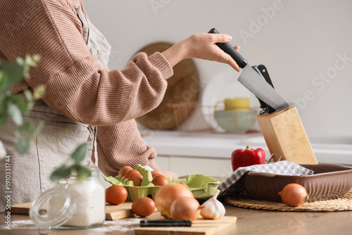 Woman taking knife from sta...
