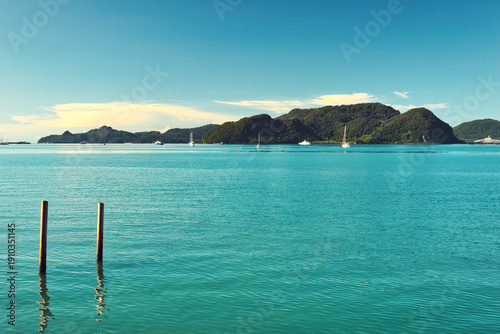 A beautiful view of Langkawi island against a beautiful blue sky with  some boats in the distance on the horizon. Tropical scenery. located at Kedah, Malaysia - September  25  2024: