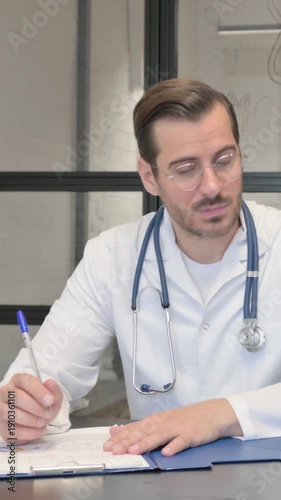 Doctor Writing Medical Report while Talking with Senior Patient, vertical video