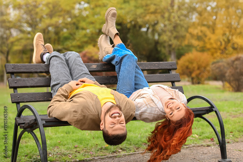 Cute young couple lying on ...