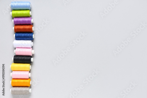 Row of colorful thread spoo...