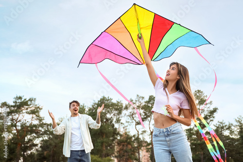 Happy young couple flying c...