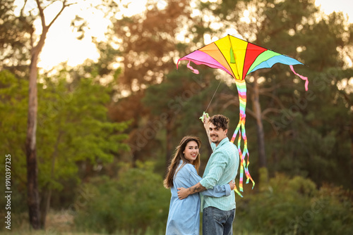 Happy young couple flying k...