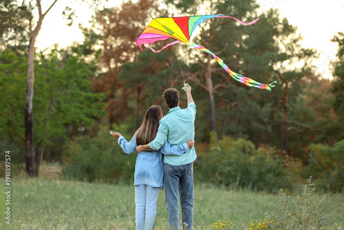 Happy young couple flying k...