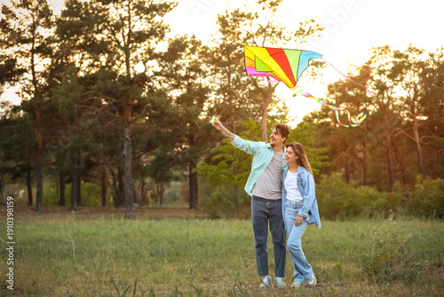 Happy young couple flying k...