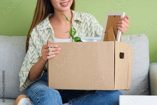 Happy young woman unpacking...