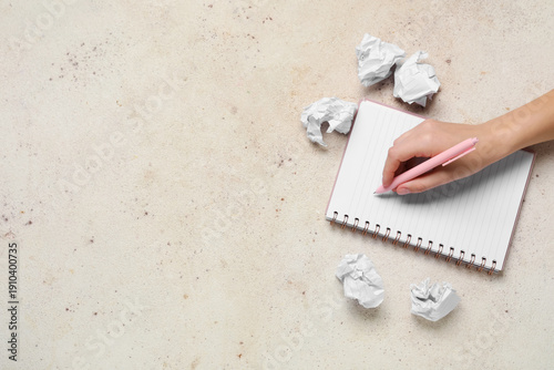 Female hand with notebook a...