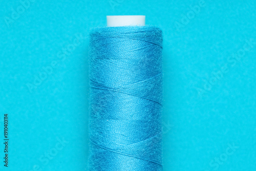 Spool of thread on blue bac...