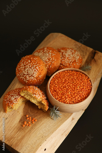 Obraz na płótnie Lentils in a wooden bowl, homemade lentil buns with sesame seeds