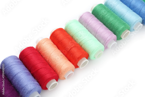 Row of colorful thread spoo...