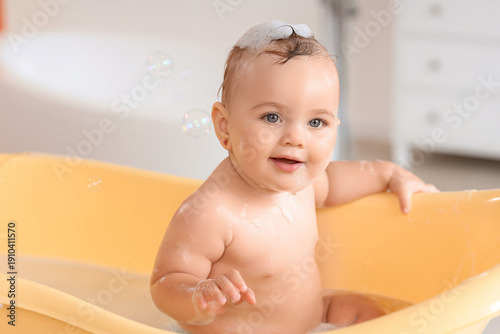 Little baby with soap bubbl...