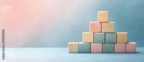 Wallpaper Mural stack of pastel wooden blocks arranged in a pyramid on a table against a textured pastel wall, calm minimalist and playful mood Torontodigital.ca