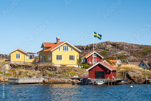 Wooden houses, boathouse and jetty in Kyrkesund coastal village, Tjörn island, Bohuslän, west coast Sweden