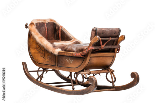 An antique wooden sleigh with fur accents placed on a black background