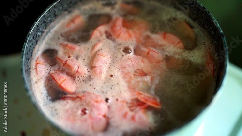 Wallpaper Mural Slow motion close-up of boiling red Brazilian langoustines in a pot on an electric stove, white protein foam visible. Seafood cooking at home. Torontodigital.ca
