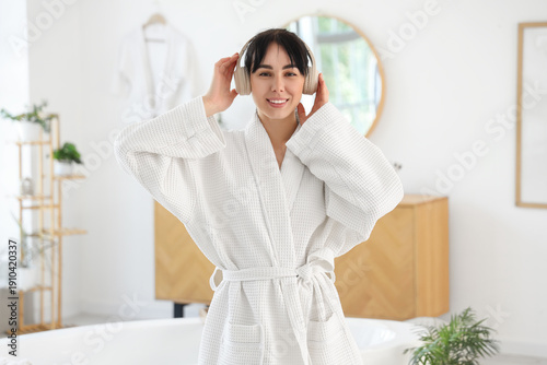 Young woman in waffle robe ...