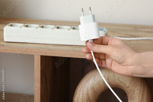 Female hand with charger at...