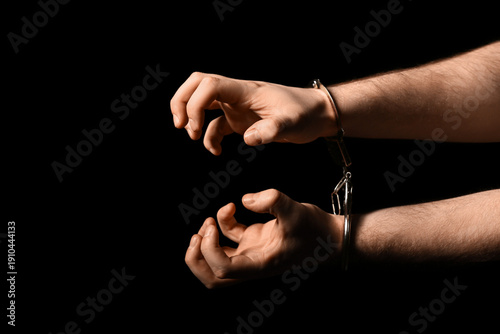 Male hands in handcuffs on ...