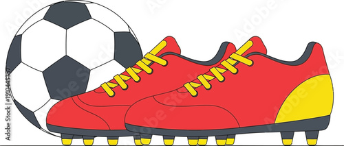 A pair of red and yellow soccer cleats rests next to a large black and white paneled football ready for a match.