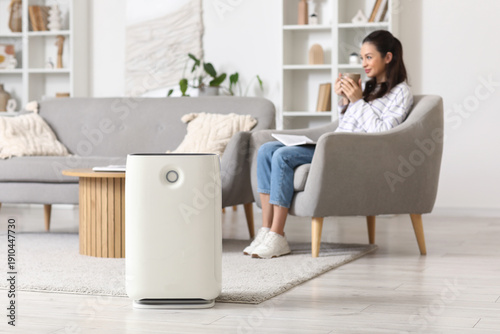 Modern air purifier on floo...
