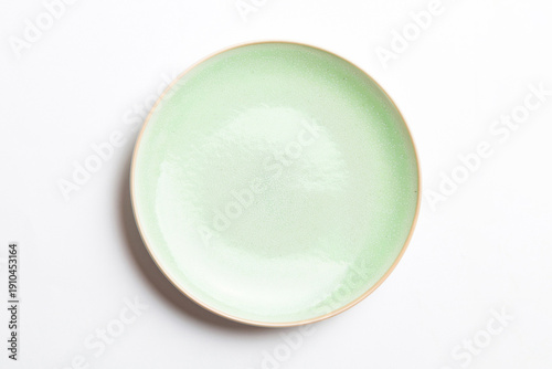Wallpaper Mural Top view of isolated of colored background empty round green plate for food. Empty dish with space for your design Torontodigital.ca
