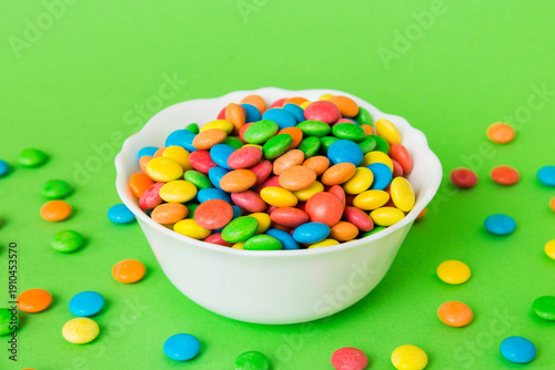 Wallpaper Mural Multicolored candies in a bowl on a colored background. birthday and holiday concept. Top view with copy space Torontodigital.ca