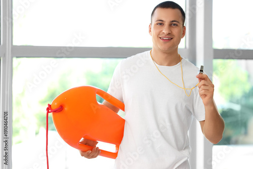 Happy male lifeguard with l...