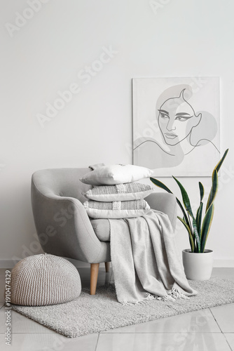 Grey armchair with stack of...